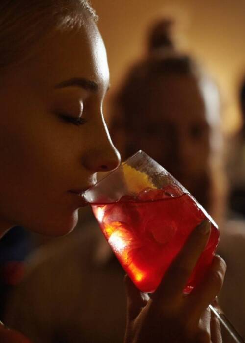 close-up-profile-of-glamorous-blonde-girl-enjoying-fresh-fruit-drink-sitting-at-bar-counter-next-to.jpg